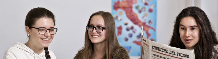 drei Mädchen lesen Zeitung