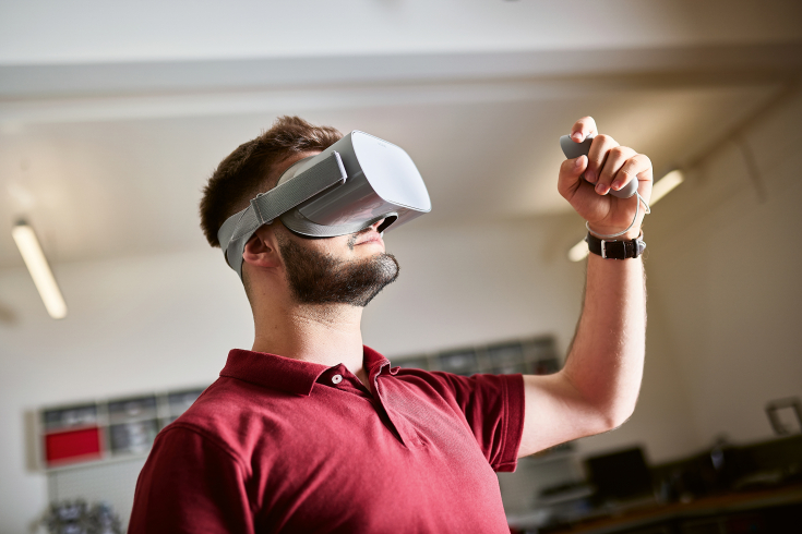 Studierender trägt eine VR-Brille